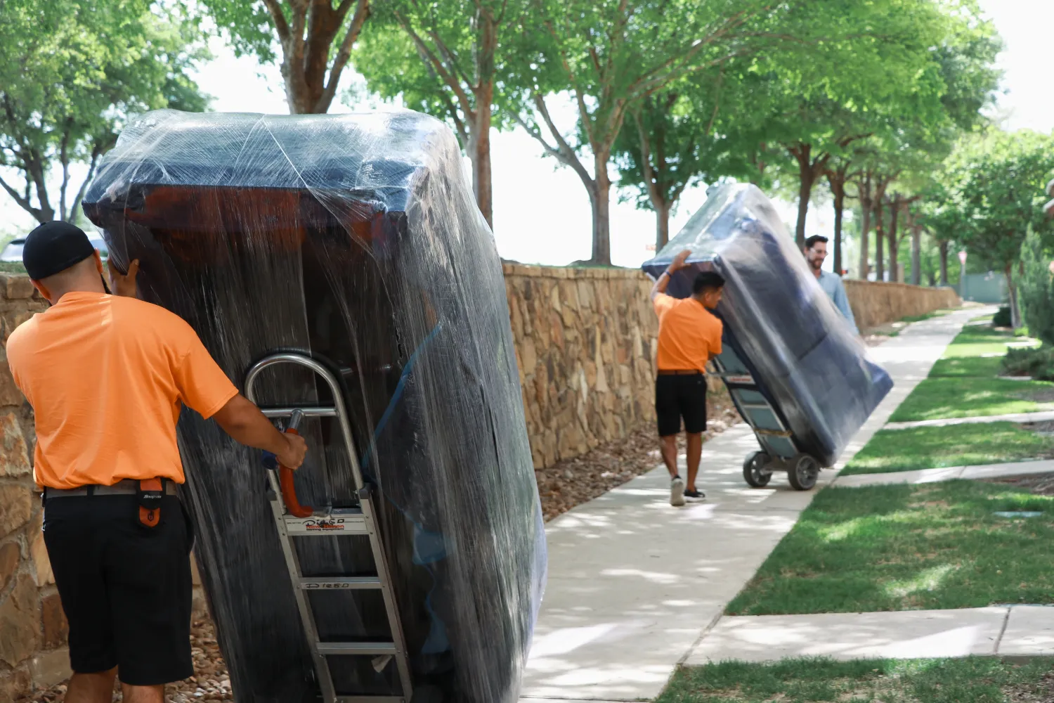 Allied movers rolling couches on dolleys